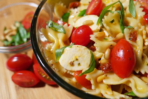 Favorite picnic food: Happier Pasta Salad recipe features tomatoes, mini mozzarella, sun-dried tomatoes and toasted pine nuts.