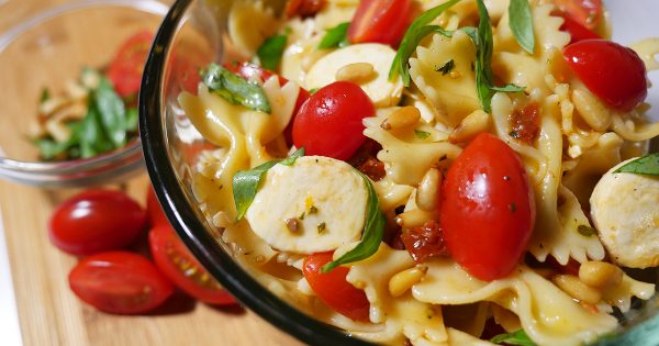 Favorite picnic food: Happier Pasta Salad recipe features tomatoes, mini mozzarella, sun-dried tomatoes and toasted pine nuts.
