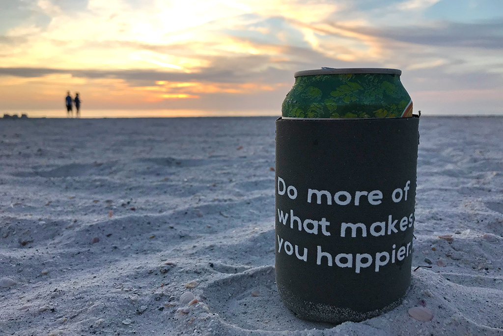 Do more of what makes you happier can cooler on the beach with sunset - benefit of moving to a happier place.
