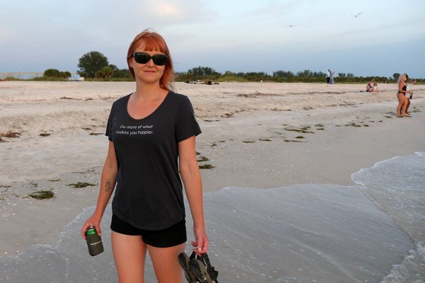 The First Happier Shirt by Happier Place on the beach in Florida at sunset.