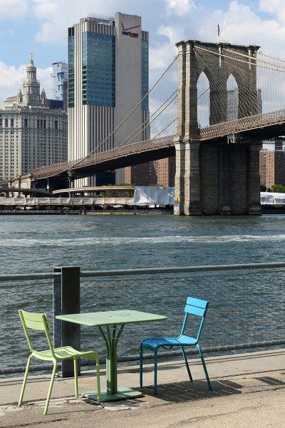 Table and chairs on Pier 1 of Brooklyn Bridge Park on the East River.