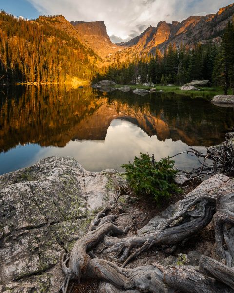 Mountain sunrise reflected in alpine lake in Rocky Mountains. Photo by Bryan Clark. Happier Place