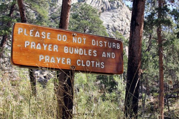 Sign at Devils Tower: please do not disturb prayer bundles and prayer cloths.