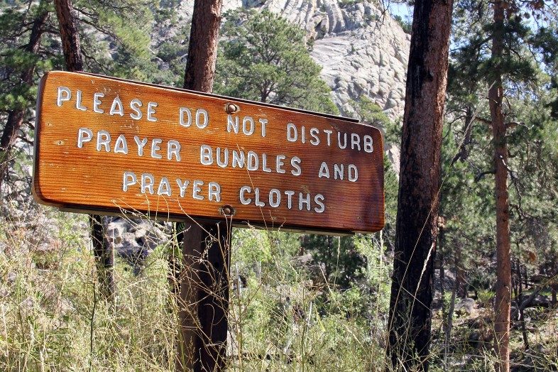 Sign at Devils Tower / Bear Lodge: please do not disturb prayer bundles and prayer cloths.