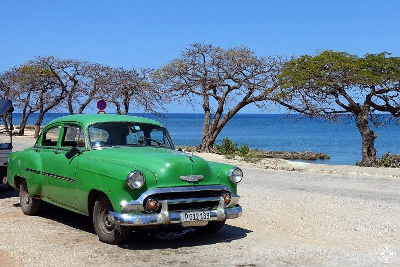 Green classic car on the waterfront in Cuba. La Boca