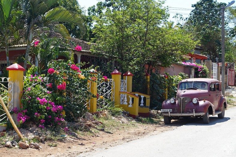 Colorful homes, abundant flowers and classic cars are typical for Cuban villages.