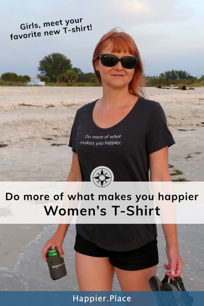 Do more of what makes you happier T-Shirt on the beach in Florida at sunset.