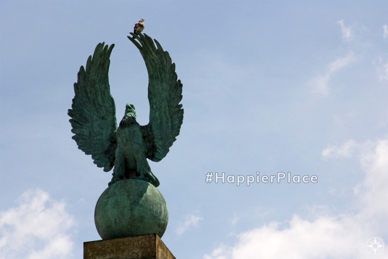 Pigeon sitting on eagle statue in Prospect Park Grand Army Plaza Brooklyn New York representing #HappierPlace