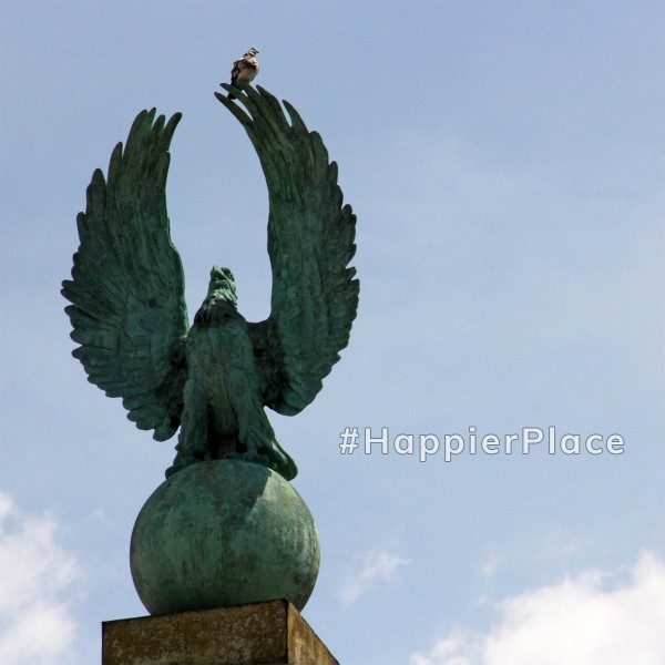 Pigeon sitting on eagle statue in Prospect Park Grand Army Plaza Brooklyn New York representing #HappierPlace