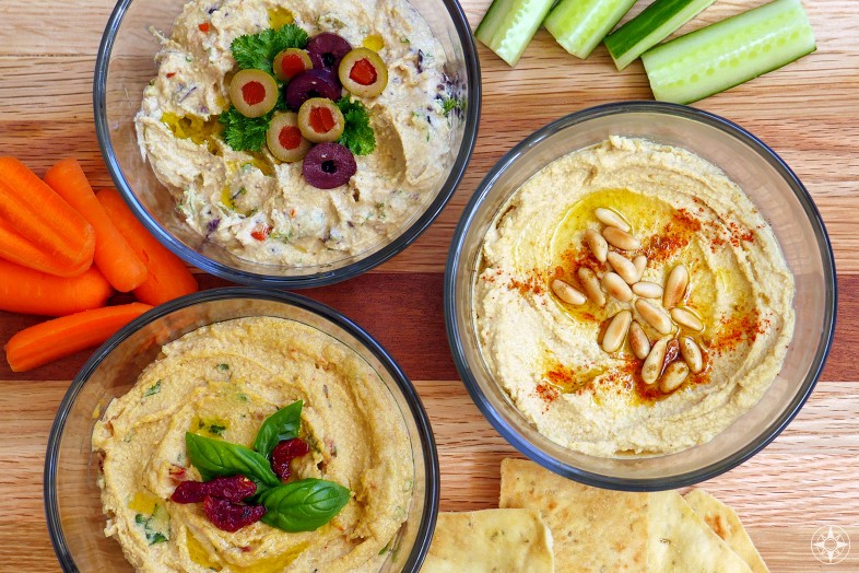 Homemade Hummus with olives sun-dried tomatoes pinenuts