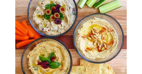Homemade Hummus with olives sun-dried tomatoes pine nuts