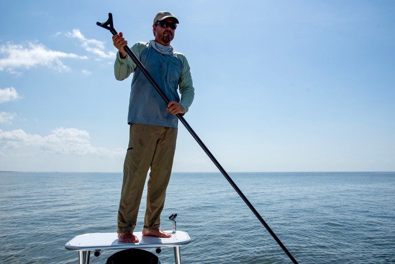 Fly fishing guide Capt. Frank Praznik's work place: standing on the platform in the back of his skiff from where he can see the fish in the clear water and pull the boat into the ideal position for his clients to catch the big one"
