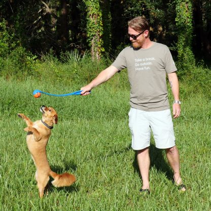 Whiskey dog playing with Scott wearing Take a Break Go Outside Have Fun Happier Place T-shirt