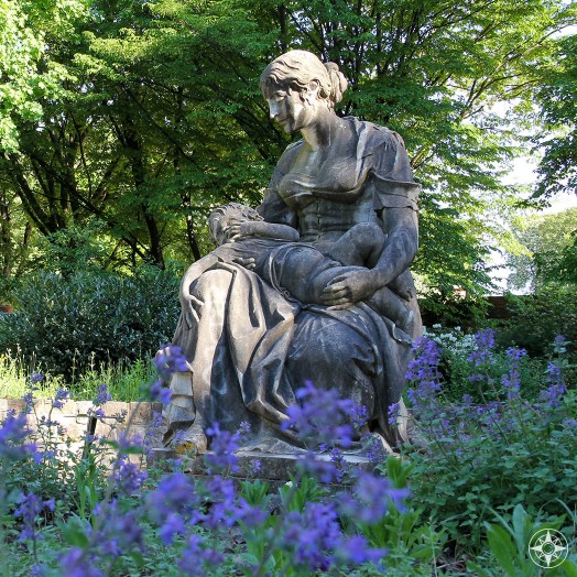 Mother statue among purple flowers in the Scent Garden