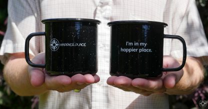 Black speckled "I'm in my happier place." enamel metal mug, front and back