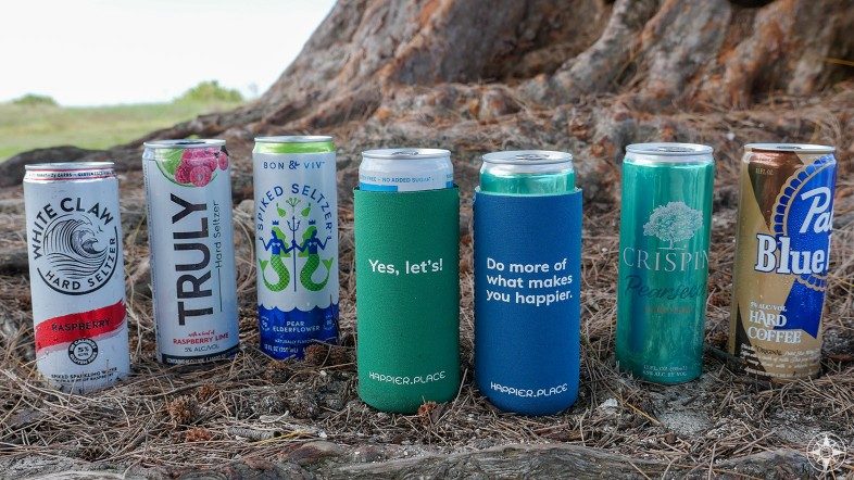 Happier Place slim can coolers fit White Claw, Truly, Bon and Viv spiked and hard seltzers, Crispin hard cider, Pabst Blue Ribbon hard coffee, Yes let's, do more of what makes you happier