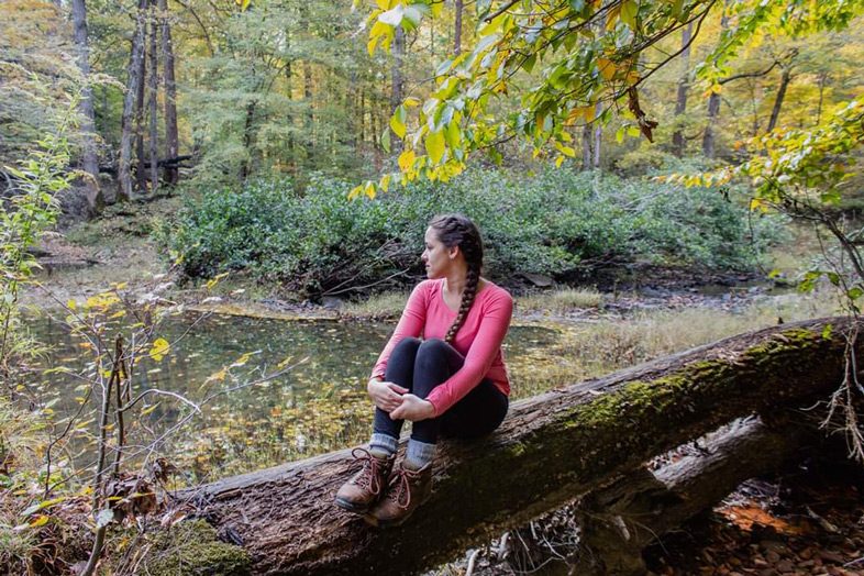 Jessica Tejera, The Walking Mermaid, sitting on a long in the Shawnee National Forest, Illinois