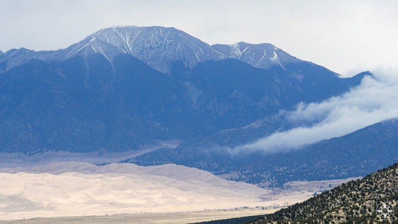View of the Great Sand Dunes dune field in the San Luis Valley and the Sangre de Cristo Mountain Range from the Zapata Falls Trail. Colorado