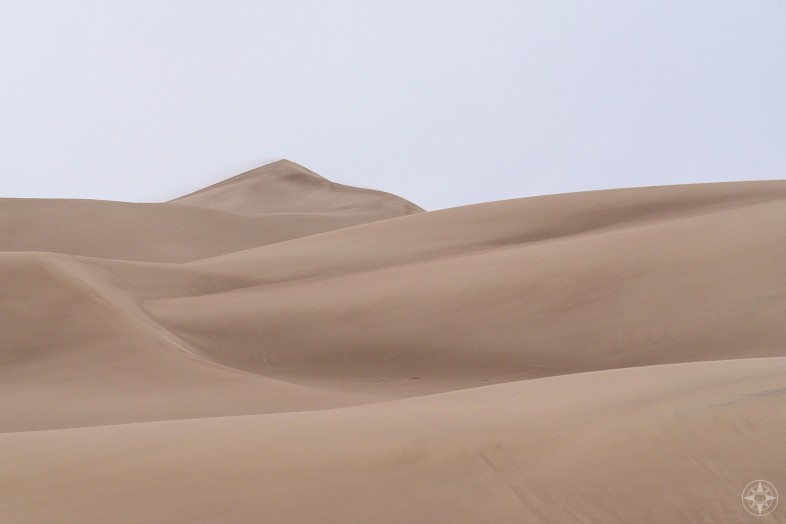 Sand dunes peak with blowing sand, Great Sand Dunes, Colorado