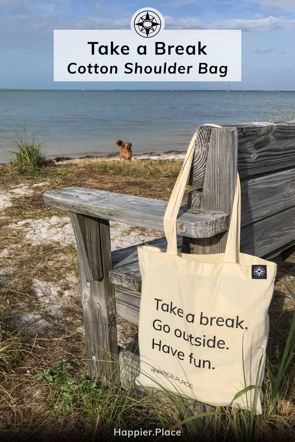 The "Take a break. Go outside. Have fun" Happier Place cotton shoulder bag hanging on a beach bench in Florida. Added fun: Whiskey Dog!
