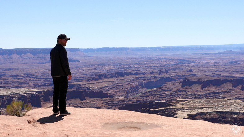 Scott near Grand View Point Overlook, taking in the breathtaking landscape of the southern part of Canyonlands.