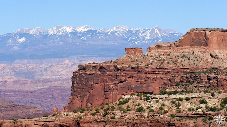Part of the large "Island in the Sky" mesa and the La Sal Mountains seen from Island in the Sky itself.