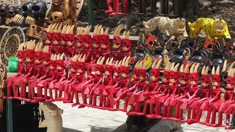 Dash of color: red wooden devils and jaguars for sale at Chichen Itza, Mexico