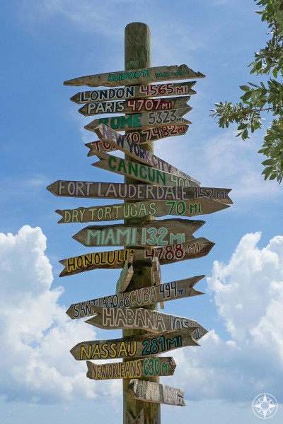Iconic, famous, wooden direction signs with cities and distances in miles, Miami, Ft. Lauderdale, London, Rome, Paris, Habana, Fort Lauderdale - on Key West, Fort Taylor Park