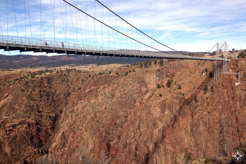 People walking across Royal Gorge Bridge suspended high above canyon wall, Canon City, Colorado