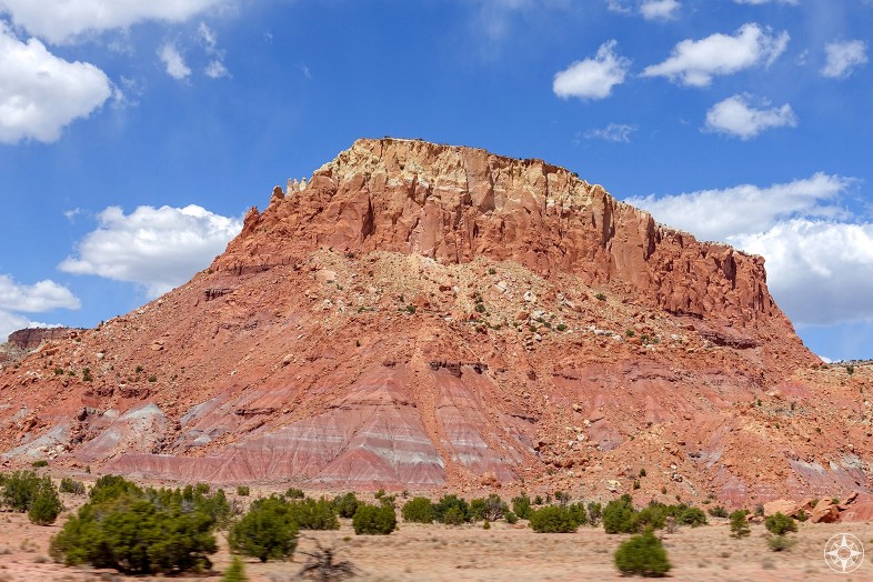 Colorful red, yellow and white mesa against blue sky along the road to ghost ranch, New Mexico