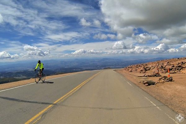 Cyclist riding up Pikes Peak Mountain Road