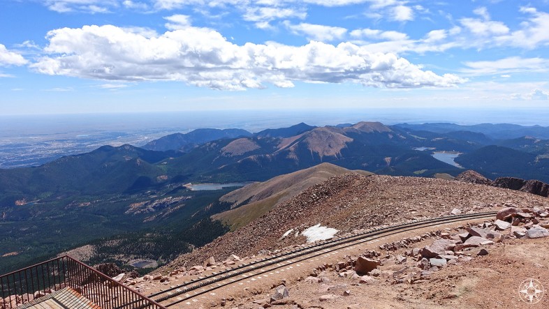 View from Pikes Peak shows the curve of planet Earth and cog trail tracks.