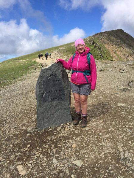 Female hiker, authors mother, stone trail sign and summit marker, Snowdon Mountain, Snowdonia, Wales, Mountains of Britain