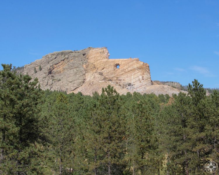 Rising from the woods of the Black Hills, giant Crazy Horse Indian warrior and leader mountain monument.