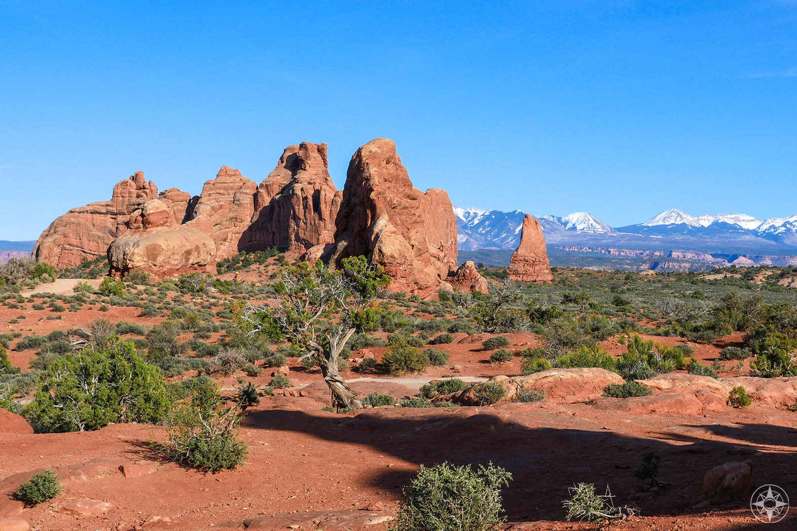 National Park Week at Arches National Park in Moab, Utah, red rock formations against snow-covered peaks and blue sky