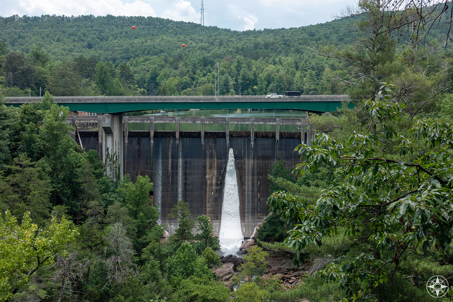 Regular water flow through opening in the hydroelectric Tallulah Dam - with the Tallulah Lake above, the gorge below and Highway 23 crossing in-between