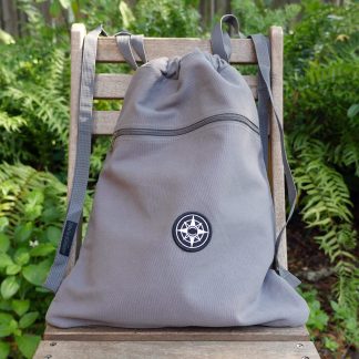 Happier Place canvas backpack, cinch bag with shoulder straps, grey, black compass logo patch, shoulder straps