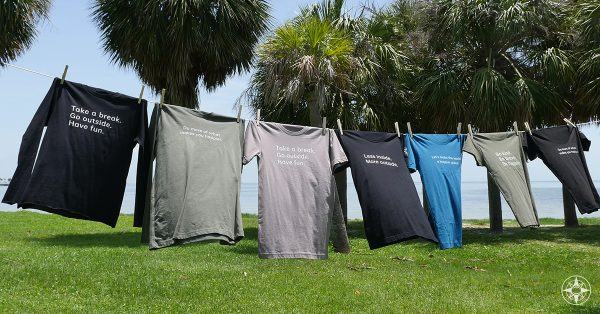 New Happier Place shirts, short sleeve, long sleeve, inspirational slogans, clothes line, seaside park, palm trees, St Pete, Florida